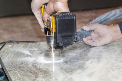 Midsection of person working in kitchen