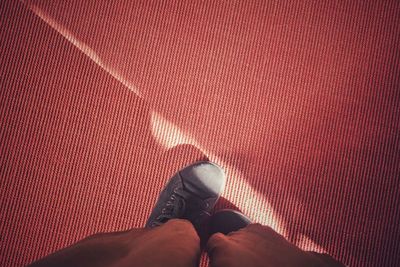 Low section of person standing on carpet