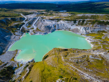 High angle view of landscape, including blue-green body of watrr