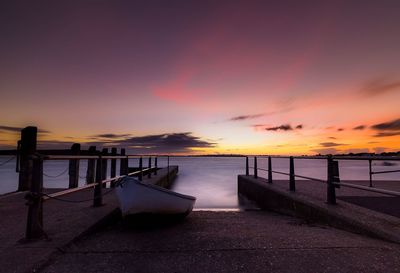 Pier on sea at sunset