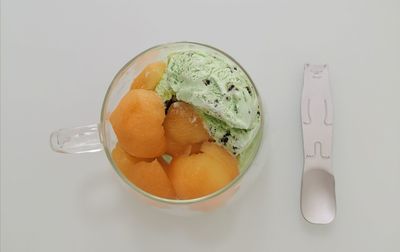 High angle view of  fresh apricot  on mint ice cream, afternoon tea time