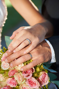 Midsection of bride holding bouquet