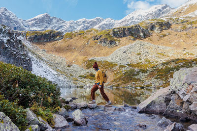 Rear view of man walking on rock