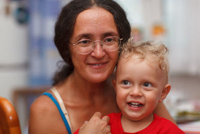 Smiling grandmother with grandson at home