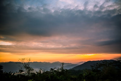 Scenic view of mountains against cloudy sky