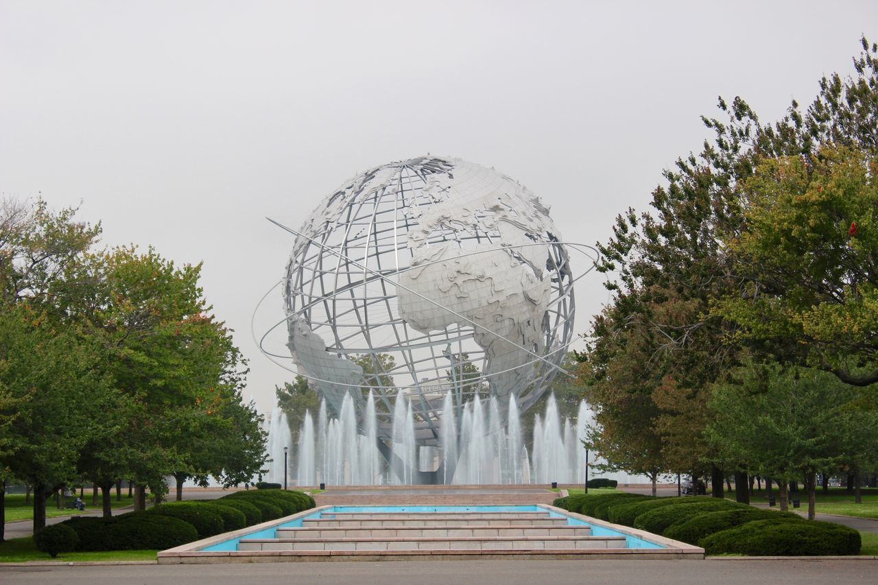 tree, built structure, architecture, sculpture, famous place, clear sky, statue, travel destinations, art and craft, fountain, building exterior, park - man made space, art, tourism, international landmark, travel, creativity, human representation, monument, formal garden