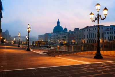 View of city lit up at dusk