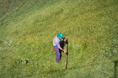 Full length of woman standing on grassy field