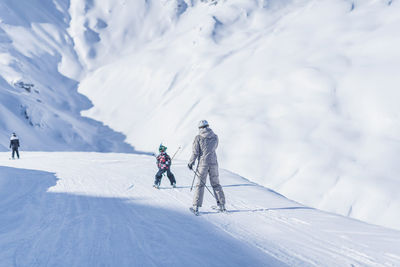 People skiing on snowcapped mountain