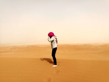 Full length of woman on sand dune