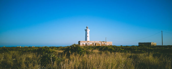 Lighthouse in the cliff at sunset