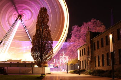 Illuminated ferris wheel at night