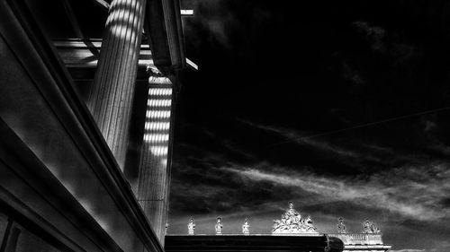 Low angle view of illuminated city against sky at night