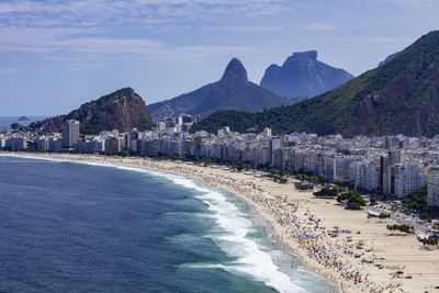 Aerial view of beach and buildings against sky