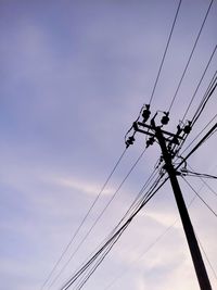 Low angle view of electricity pylon against sky