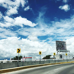 Road by city against sky