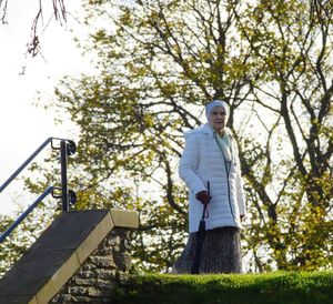 Low angle view of woman standing by tree