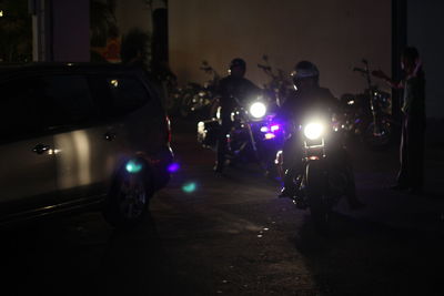 People on illuminated street at night
