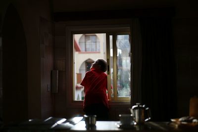 Rear view of man standing in corridor