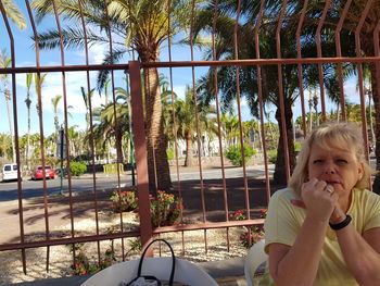 Portrait of smiling boy on palm trees