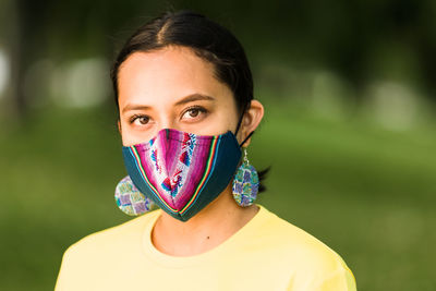 Portrait of beautiful young woman covering face