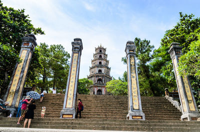 Group of people outside temple against building