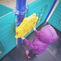 Low section of person with multi colored umbrella