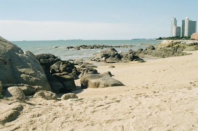 Rocks on beach against sky