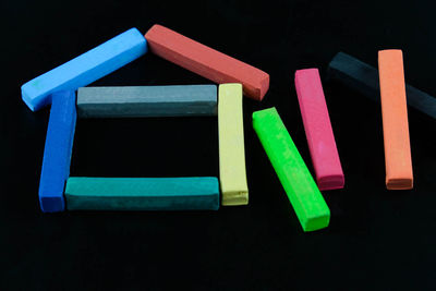 Close-up of multi colored crayons over black background