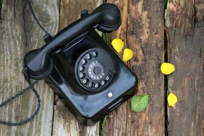 Close-up of telephone on wooden table