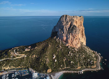 Panoramic view of rock formation in sea against sky