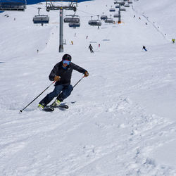 High angle view of people skiing on snow field