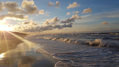 Scenic view of beach against sky during sunset