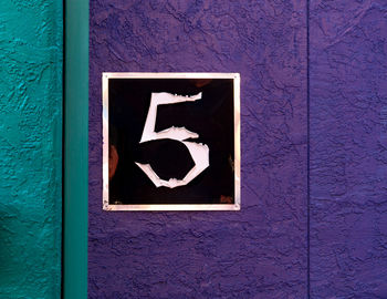 Number 5 on purple wall