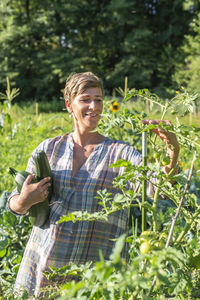 Smiling woman standing in farm