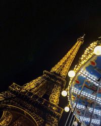 Low angle view of illuminated buildings against sky at night