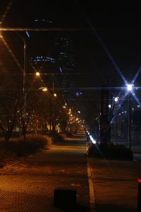 Illuminated road in city at night