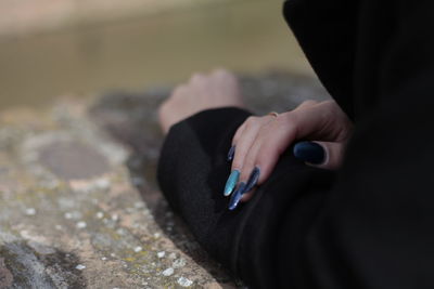 Cropped image of woman showing nail polish