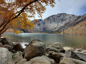 Rocks by lake against mountains