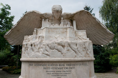 Statue of cemetery against trees