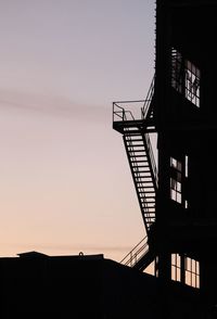 Low angle view of silhouette building against sky during sunset