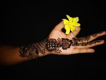 Midsection of woman holding flower