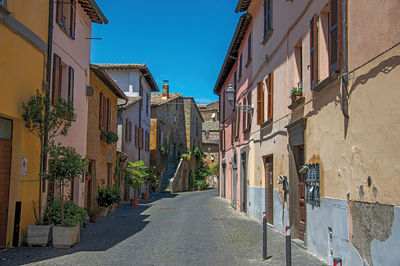 Overview of an alley with old buildings and garage in orvieto, italy.