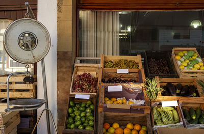 Facade of rural greengrocer's with old scales and wooden crates