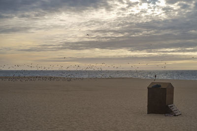 Scenic view of beach against sky during sunset