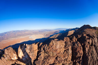 Scenic view of mountains against clear blue sky