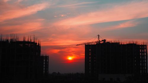 Silhouette of construction site during sunset