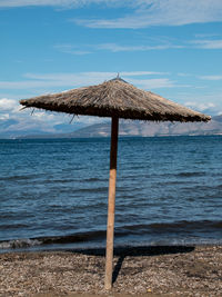 Lifeguard hut on beach against sky