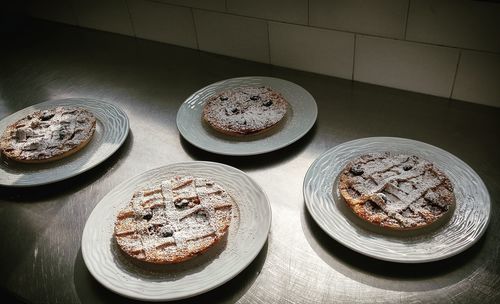 High angle view of tarts served in plates on table