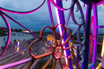 Close-up of chain swing ride at night
